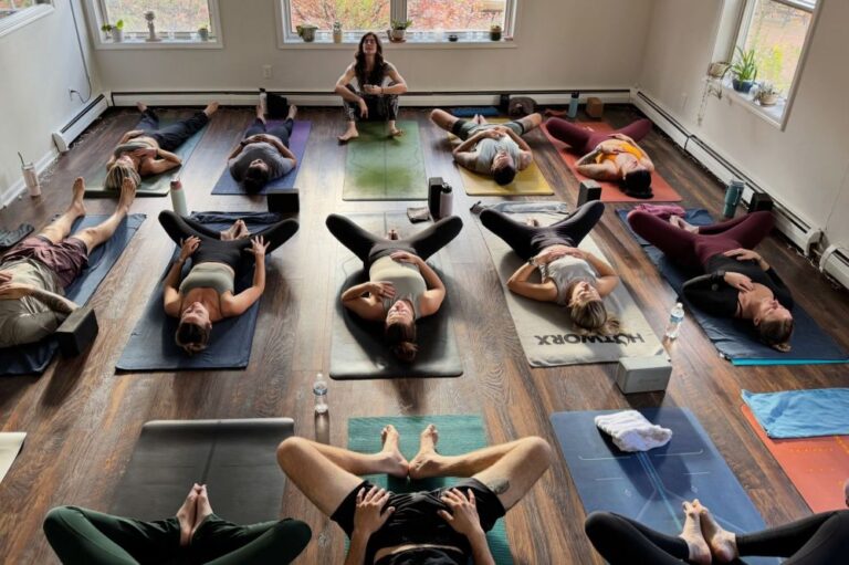 Participants lying on exercise mats during a guided group fitness session