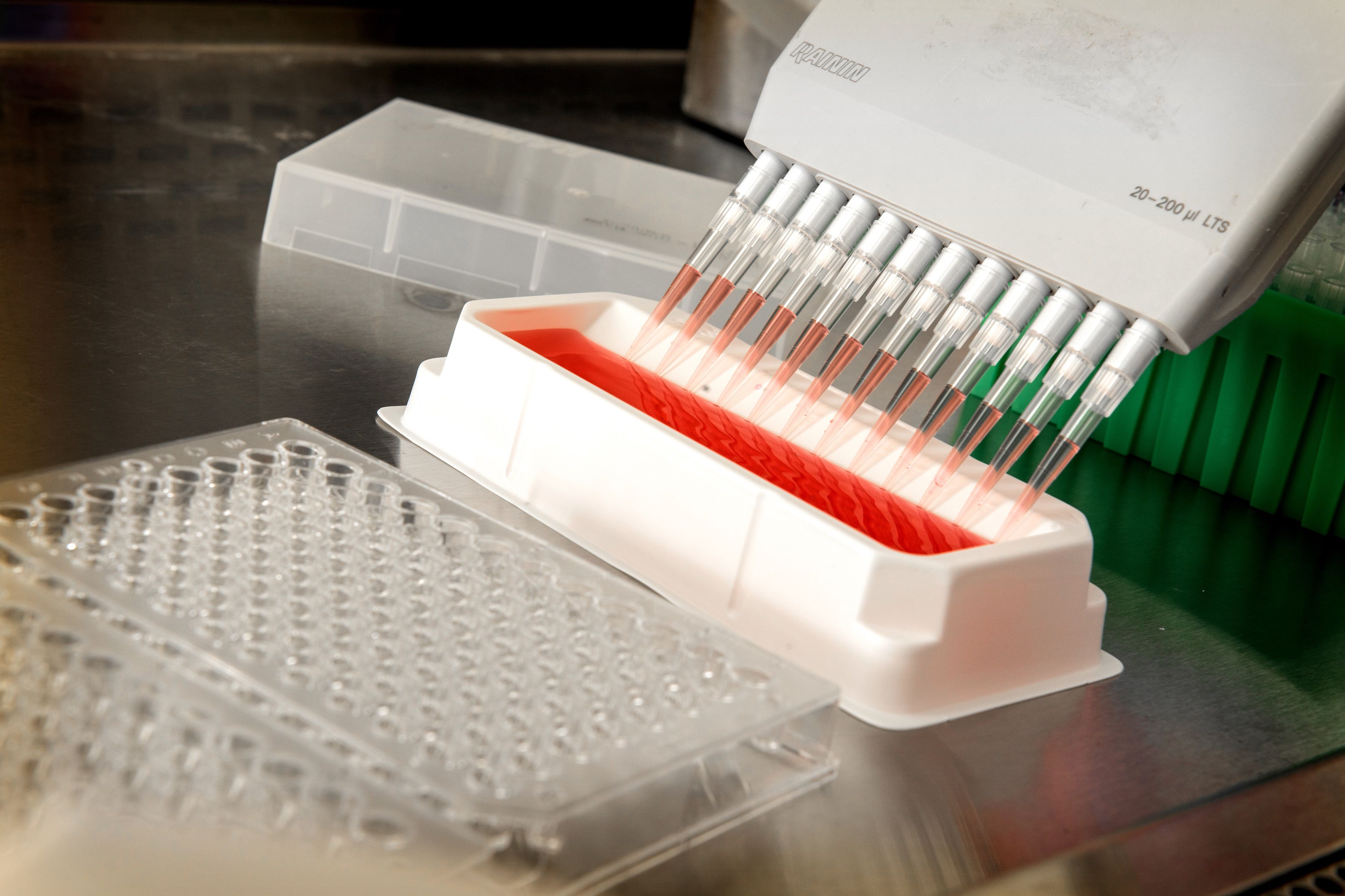 Automated pipette dispensing liquid in a laboratory during peptide research